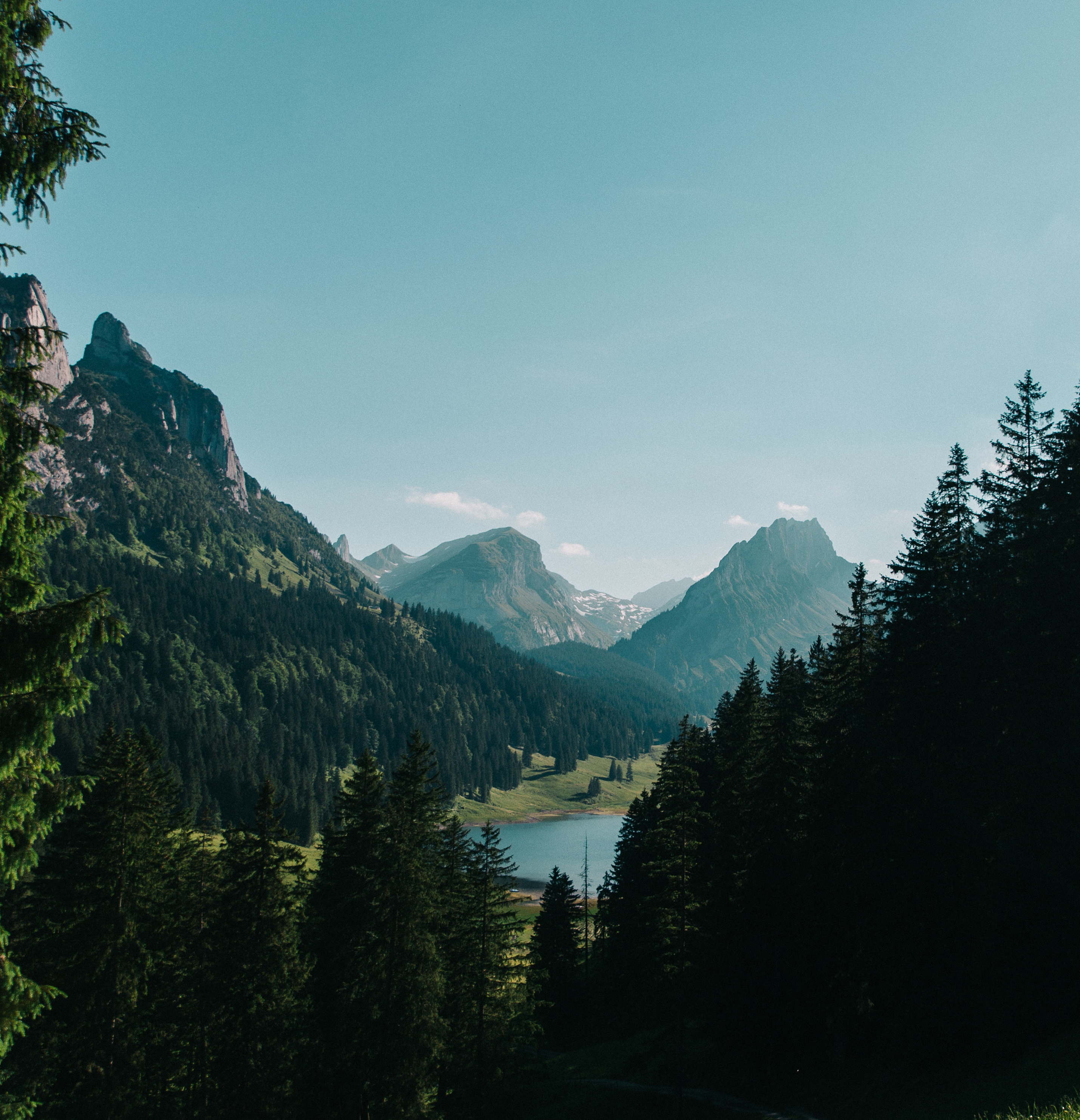 A photograph of mountains in the distance with a lake below