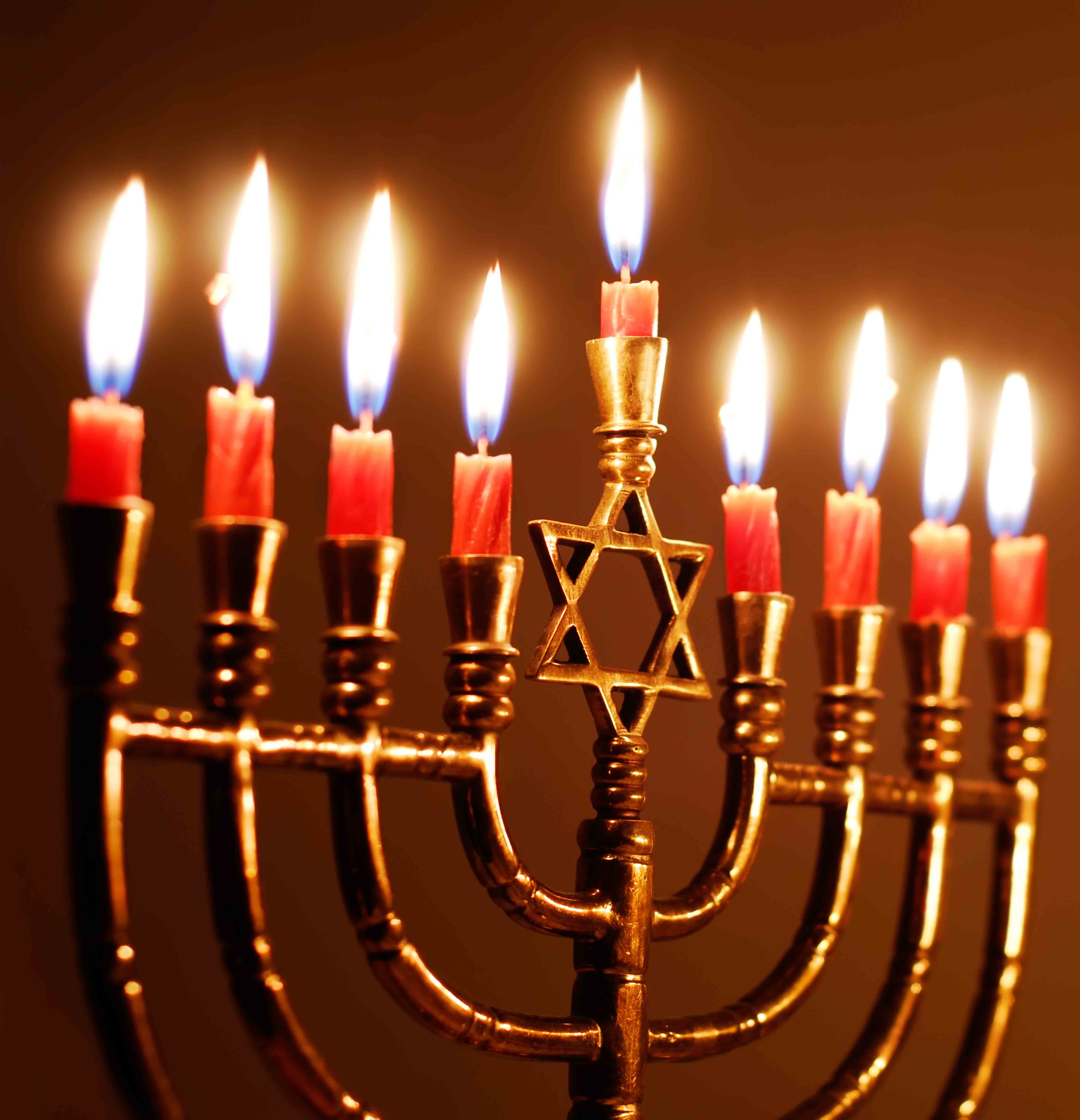 gold menorah with all candles lit