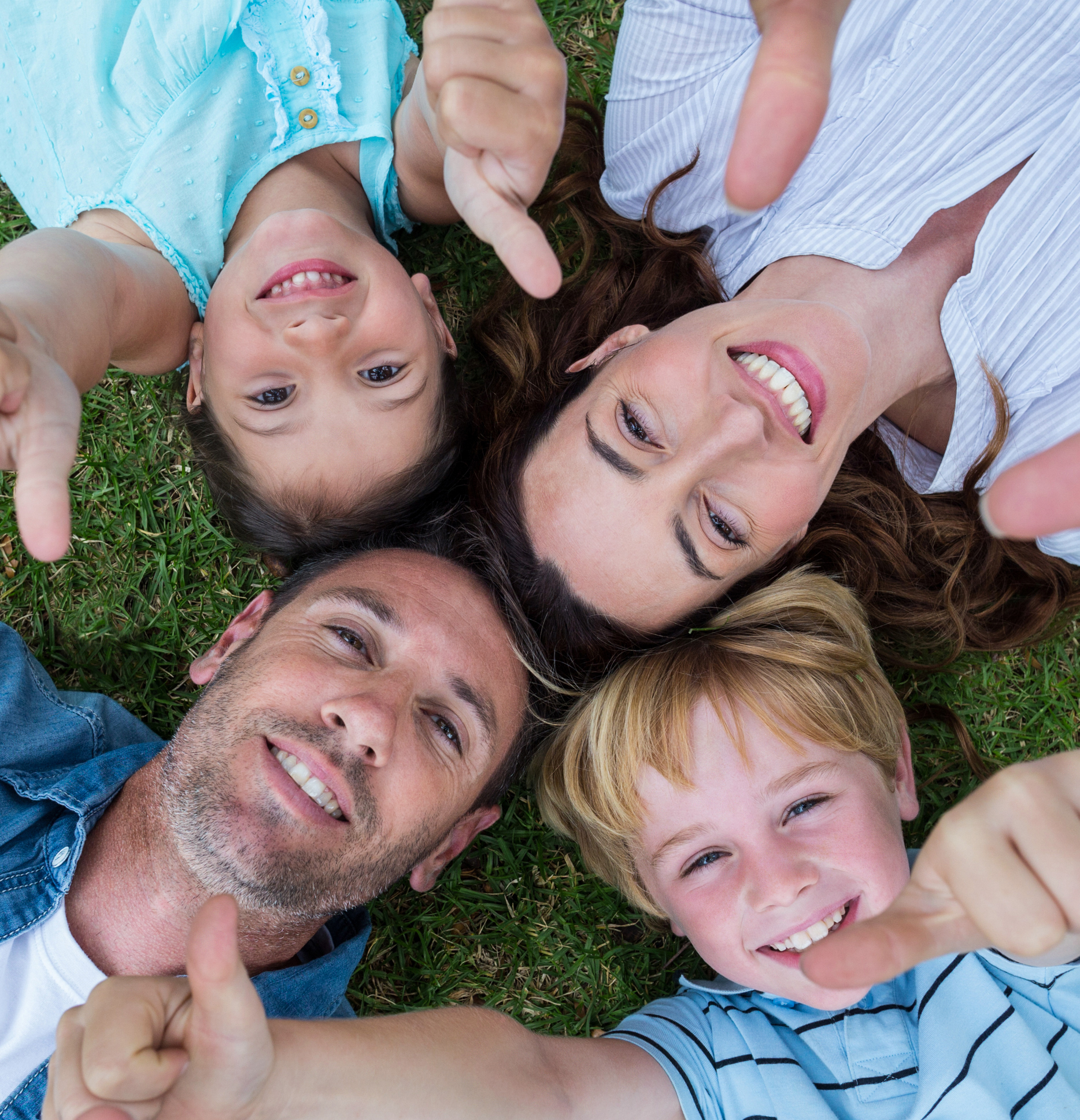 Image of family lying on their backs in circle with heads together