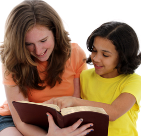 Two people reading a book together
