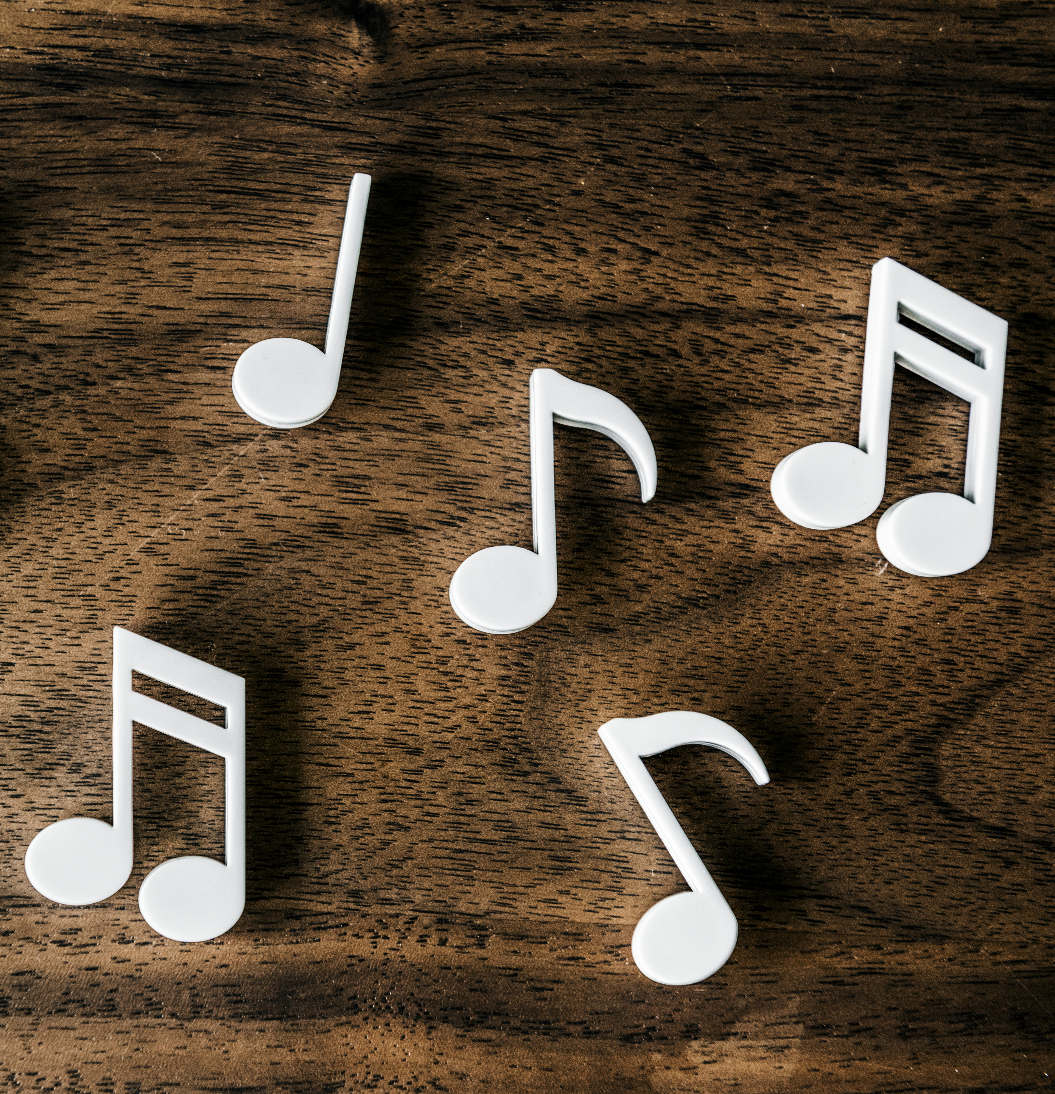 White music notes on a wooden table