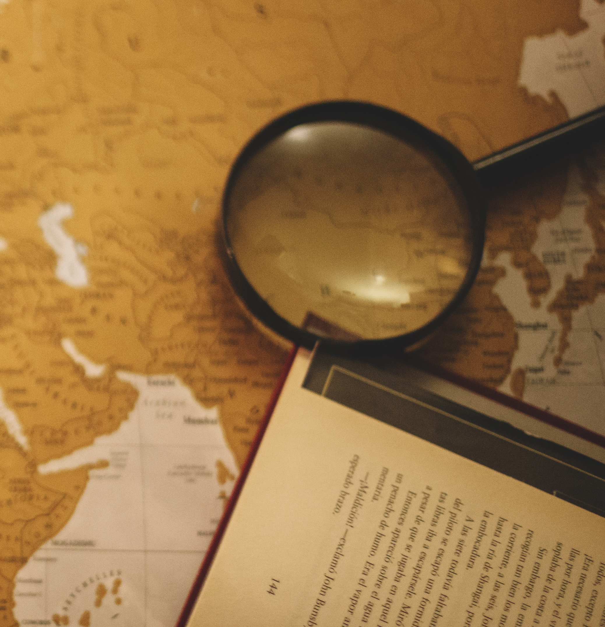 map with book and magnifying glass