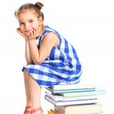 Child sitting on books