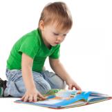 Toddler reading on floor