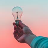 person holding a lightbulb