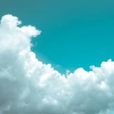 Photograph of a blue sky with puffy clouds