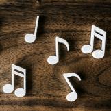A collection of white music notes on a table top