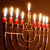 gold menorah with all candles lit