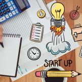 Image of calculator, spreadsheet, coffee cup with line drawing of a lightbulb in a rocketship layered over top