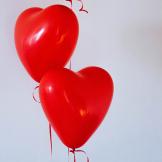Two red, heart-shaped balloons