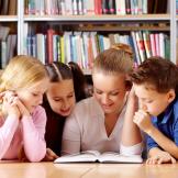kids and teacher reading together