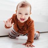 A baby crawling and reaching out