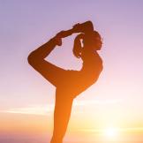 person doing yoga at sunrise