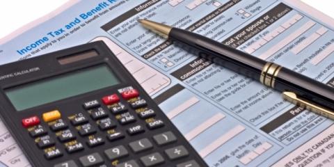 tax form, calculator, and pen