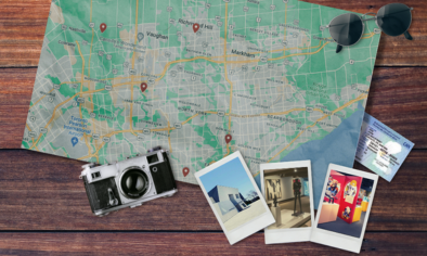 map of Ontario on table with photos, camera, and sunglasses