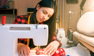 woman using sewing machine