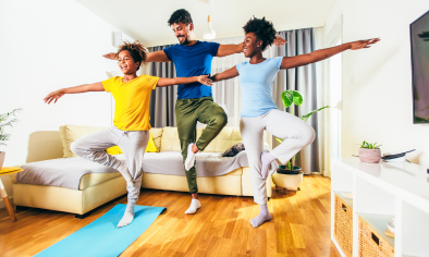 family doing yoga in living room