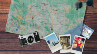 map of Ontario on table with photos, camera, and sunglasses