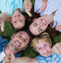 Image of family lying on their backs in circle with heads together