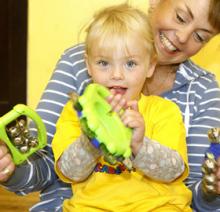 A woman with a little girl on her lap with musical instruments