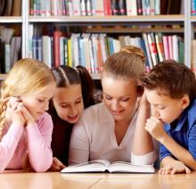 kids and teacher reading together